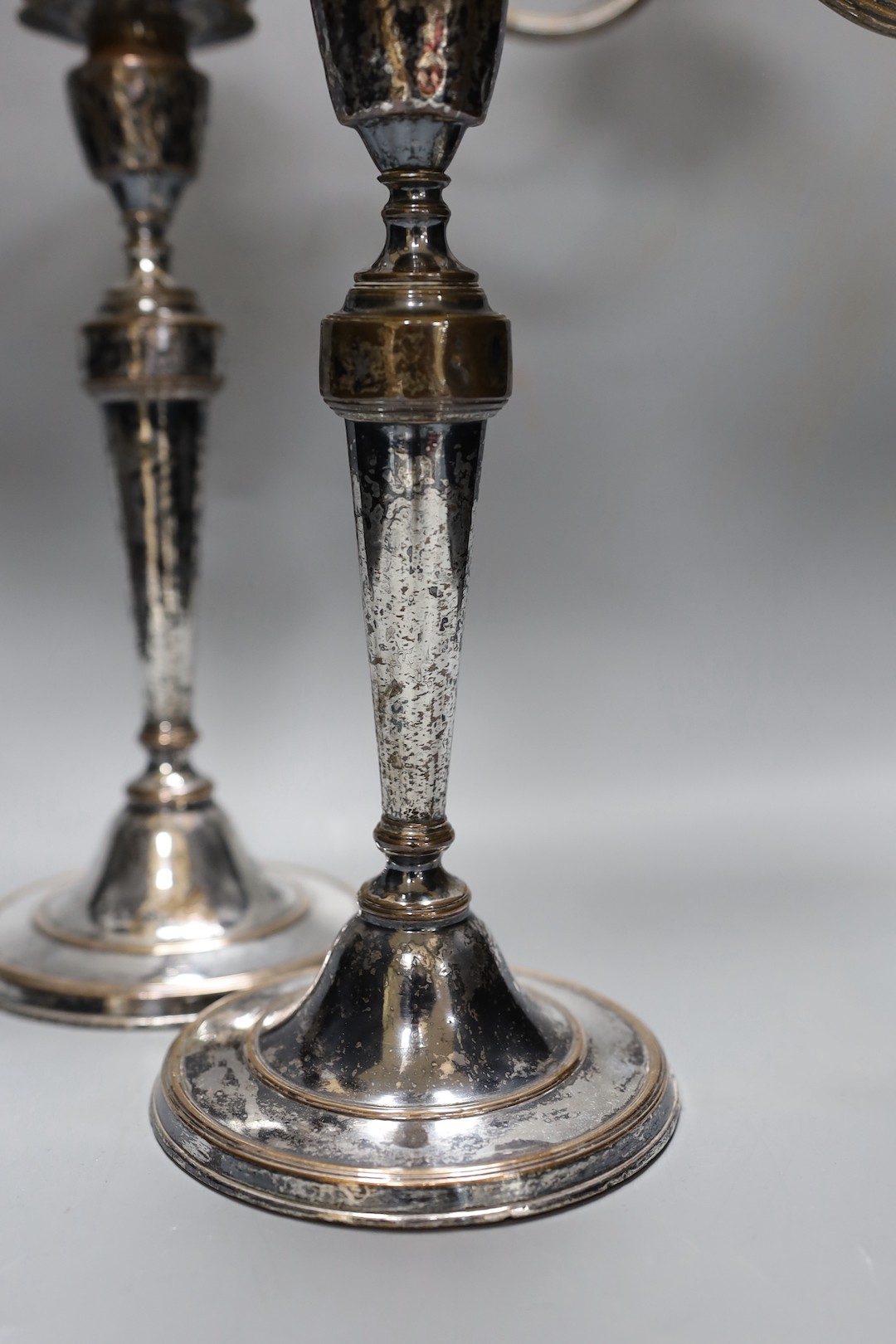 A pair of Sheffield plate two-branch twin-light candelabra, 37 cms high.